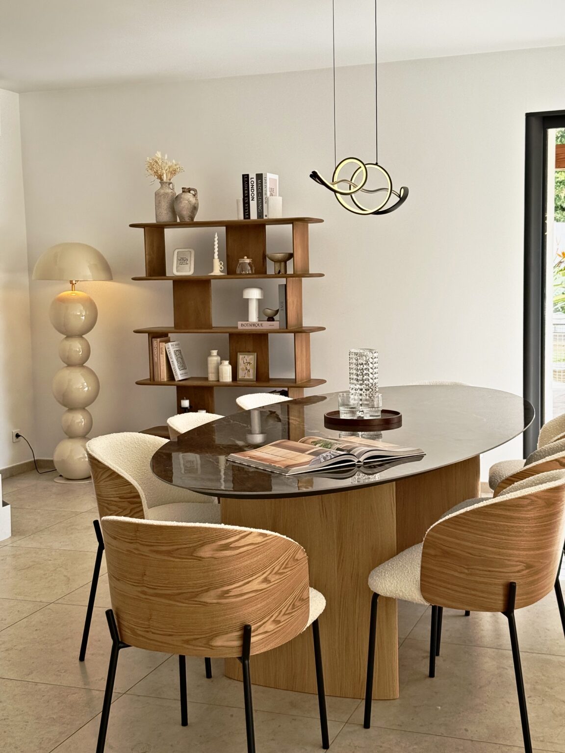 Table ovale, bibliothèque en bois et lampe boules – villa Nova à Vence